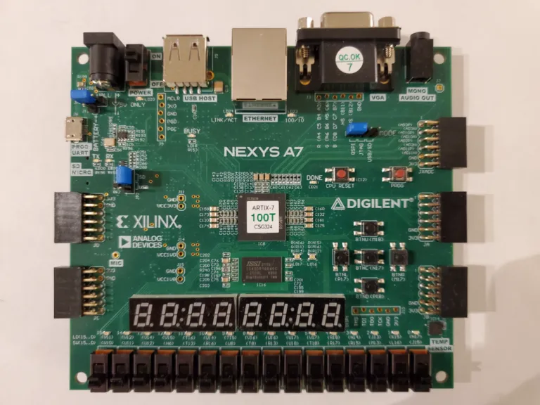 A Nexys A7 FPGA board with its eight-digit seven-segment display, push buttons, and switches